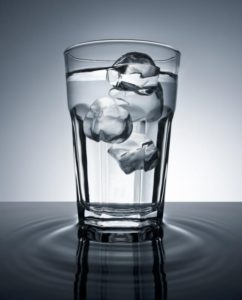 Ice floating in a glass of still water